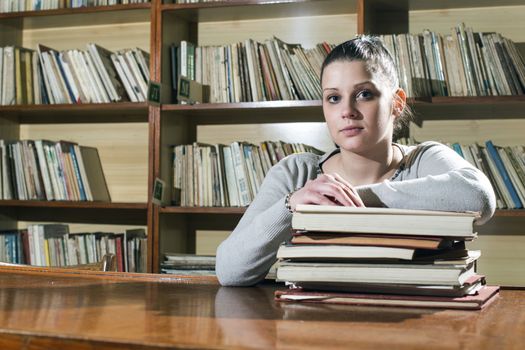 Student girl in a library. Looking at book