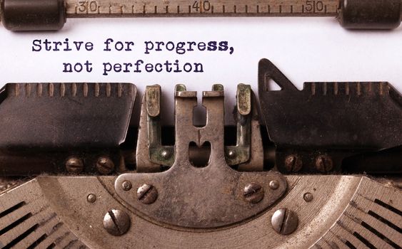 Strive for progress, not perfection - Written on an old typewriter, vintage