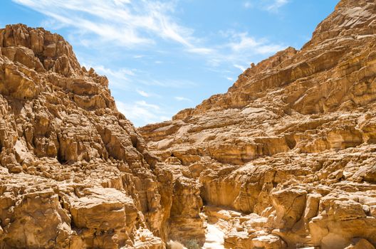 high rocky mountains in the desert against the blue sky and white clouds in Egypt Dahab