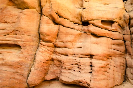 texture of orange stone rock in a colored canyon closeup