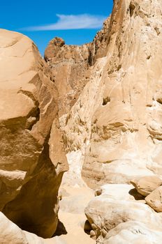 high rocky mountains against the blue sky and white clouds in the desert
