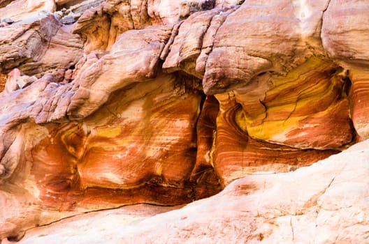 texture of orange stone rock in a colored canyon closeup