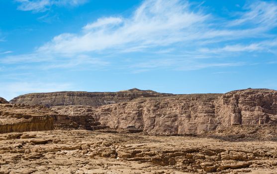 high rocky mountains in the desert against the blue sky and white clouds in Egypt Dahab