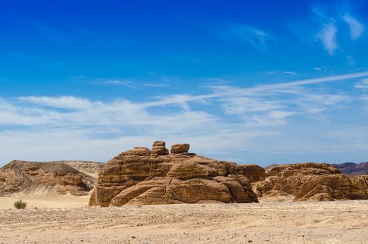 high rocky mountains against the blue sky and white clouds in the desert in Egypt Dahab South Sinai