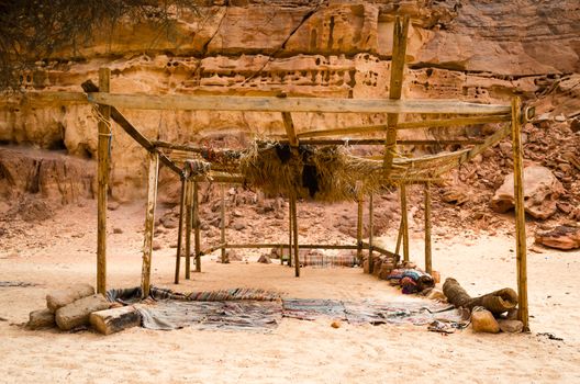 dilapidated bedouin habitation against a cliff in a colored canyon