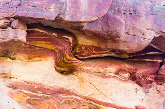 texture of orange stone rock in a colored canyon closeup