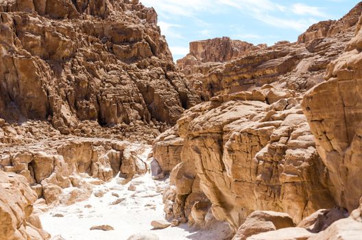 high rocky mountains in the desert against the blue sky and white clouds in Egypt Dahab