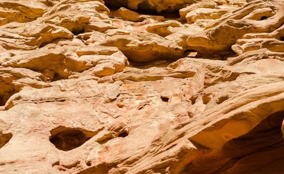 texture of orange stone rock in a colored canyon closeup
