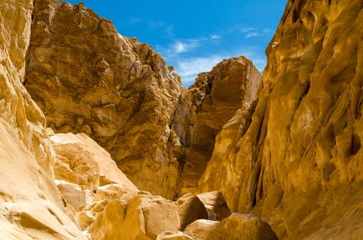 high rocky mountains against the blue sky and white clouds in the desert in Egypt Dahab South Sinai