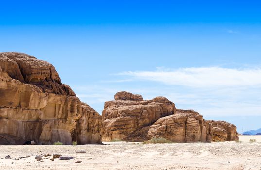 high rocky mountains against the blue sky and white clouds in the desert in Egypt Dahab South Sinai