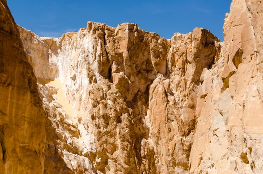 high rocky mountains against the blue sky and white clouds in the desert in Egypt Dahab South Sinai