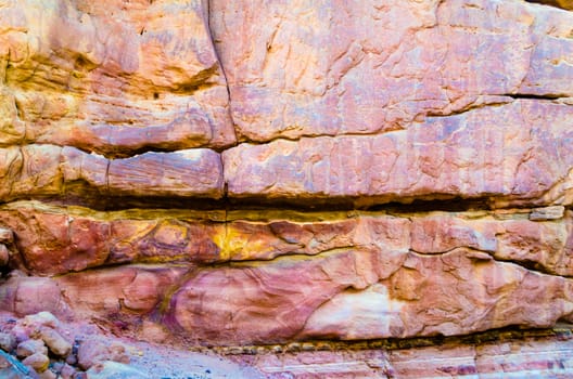 texture of orange stone rock in a colored canyon closeup