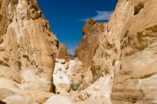 high rocky mountains against the blue sky and white clouds in the desert