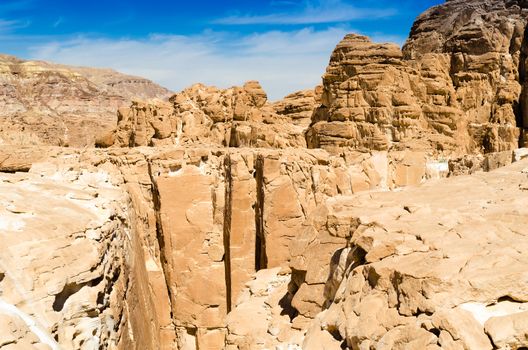 high rocky mountains against the blue sky and white clouds in the desert in Egypt Dahab South Sinai