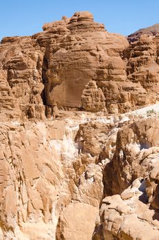 high rocky mountains against the blue sky and white clouds in the desert in Egypt Dahab South Sinai