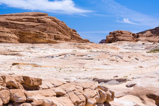 high rocky mountains against the blue sky and white clouds in the desert in Egypt Dahab South Sinai