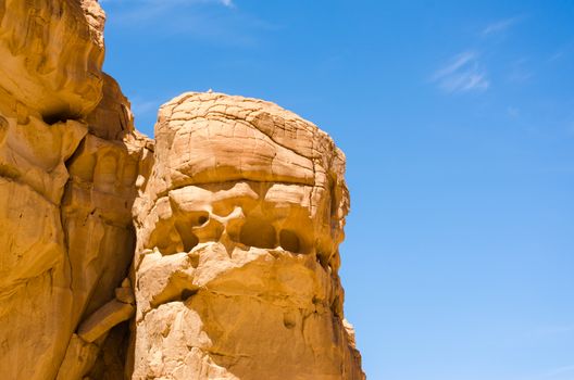 high rocky mountains against the blue sky and white clouds in the desert in Egypt Dahab