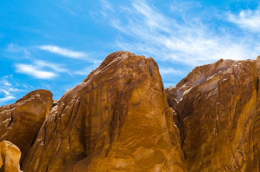 high rocky mountains against the blue sky and white clouds in the desert in Egypt Dahab South Sinai