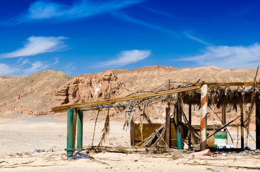 ruins in the desert against the backdrop of rocky mountains and blue sky with white clouds in Egypt