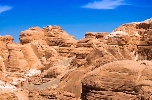 peaks of high stone rocks against a blue sky in Egypt Dahab
