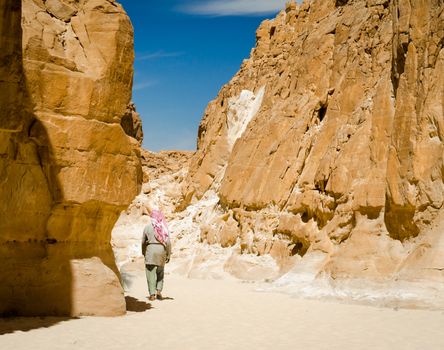 Bedouin walks among the rocks in a desert canyon in Egypt Dahab