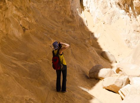 girl photographer takes pictures of the mountains in the canyon in Egypt Dahab South Sinai