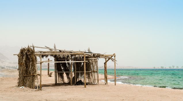 palm tree hut with garbage on the shores of the Red Sea in Egypt
