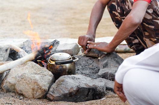 old kettle by the fire and people sitting next