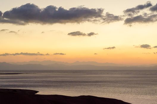 sunrise landscape Red Sea coast with silhouette of high mountains and sky with clouds