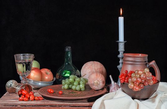 autumn still life with vegetables fruits and candle