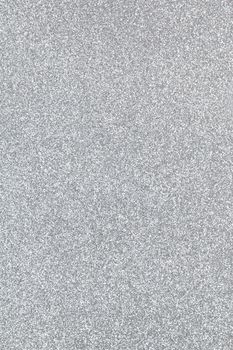 Silver coloured sparkling festive background, close-up. Copy space for text. Vertical. Celebration, holidays, sales, fashion concept, harvesting for mock up.