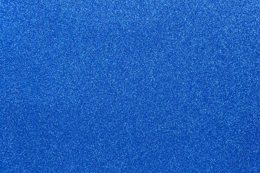 Blue coloured sparkling festive background, close-up. Copy space for text. Horizontal. Celebration, holidays, sales, fashion concept, harvesting for mock up.