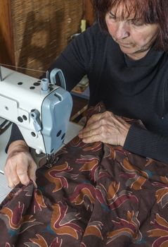Woman sewing on a sewing machine. 