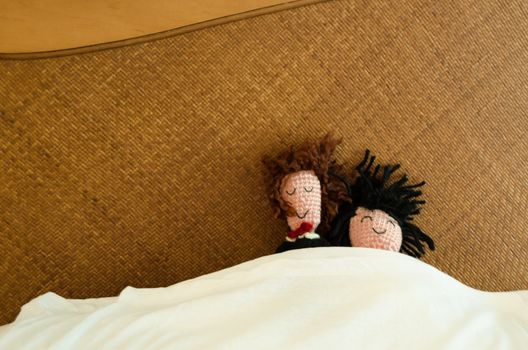 Wool groom and bride puppets sharing theis honeymoon first morning