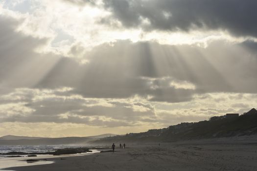 Rays of sunlight piercing through cloudy afternoon sky on a vacation beach, Mossel Bay, South Africa