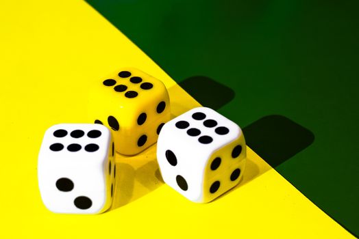 white and yellow dice on a combined green and yellow background