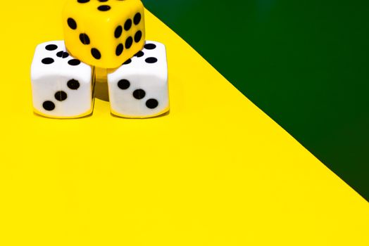 white and yellow dice on a combined green and yellow background