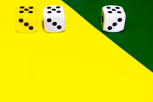 white and yellow dice on a combined green and yellow background