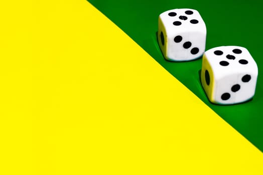 white and yellow dice on a combined green and yellow background