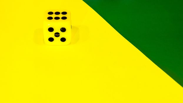 white and yellow dice on a combined green and yellow background