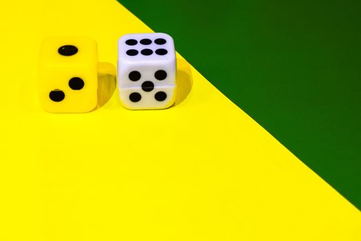 white and yellow dice on a combined green and yellow background