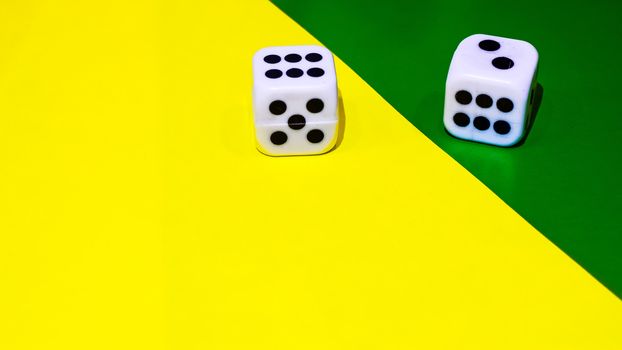 white and yellow dice on a combined green and yellow background