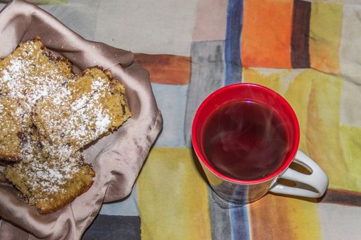 Oatmeal and walnut cookies on colorful surface accompanied with coffee