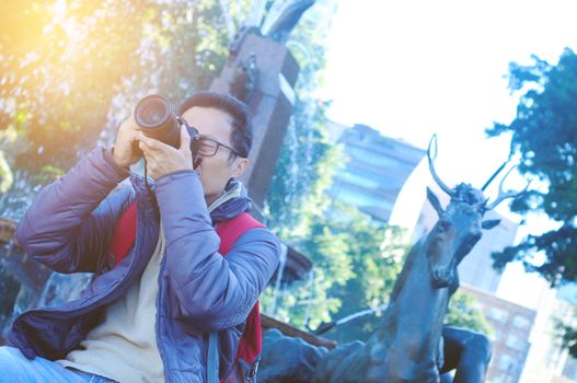 Male tourist taking picture in the city