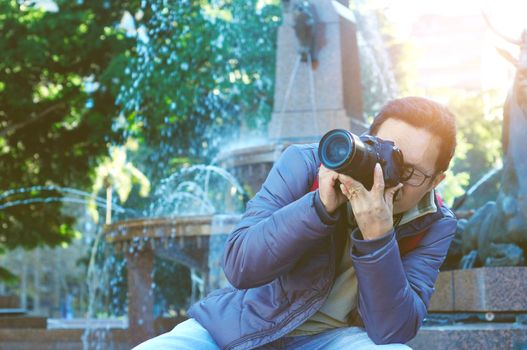 Male tourist taking picture in the city