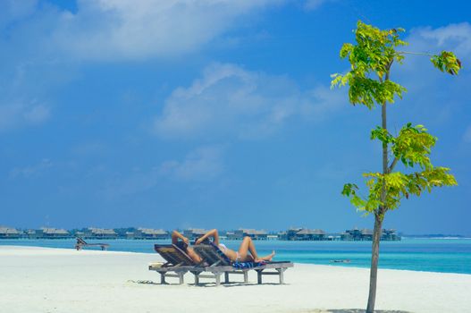 Couple on a tropical beach at Maldives