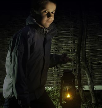 Child walk in the darkness with gas lantern