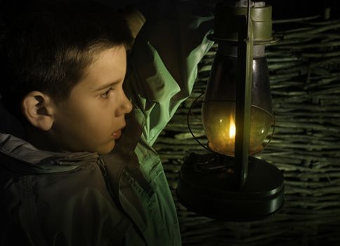 Child walk in the darkness with gas lantern