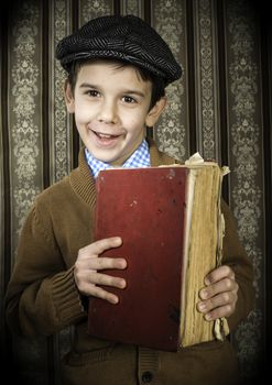 Child with red vintage book. Vintage clothes and hat