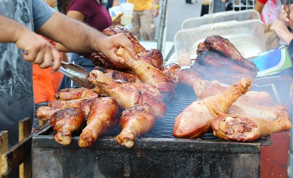 Grilled chicken BBQ grilled on burning charcoal on street food outdoor festival time at San Francisco, USA.